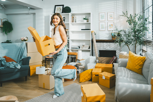 Woman moving out of her apartment while trying to clean and stay organized